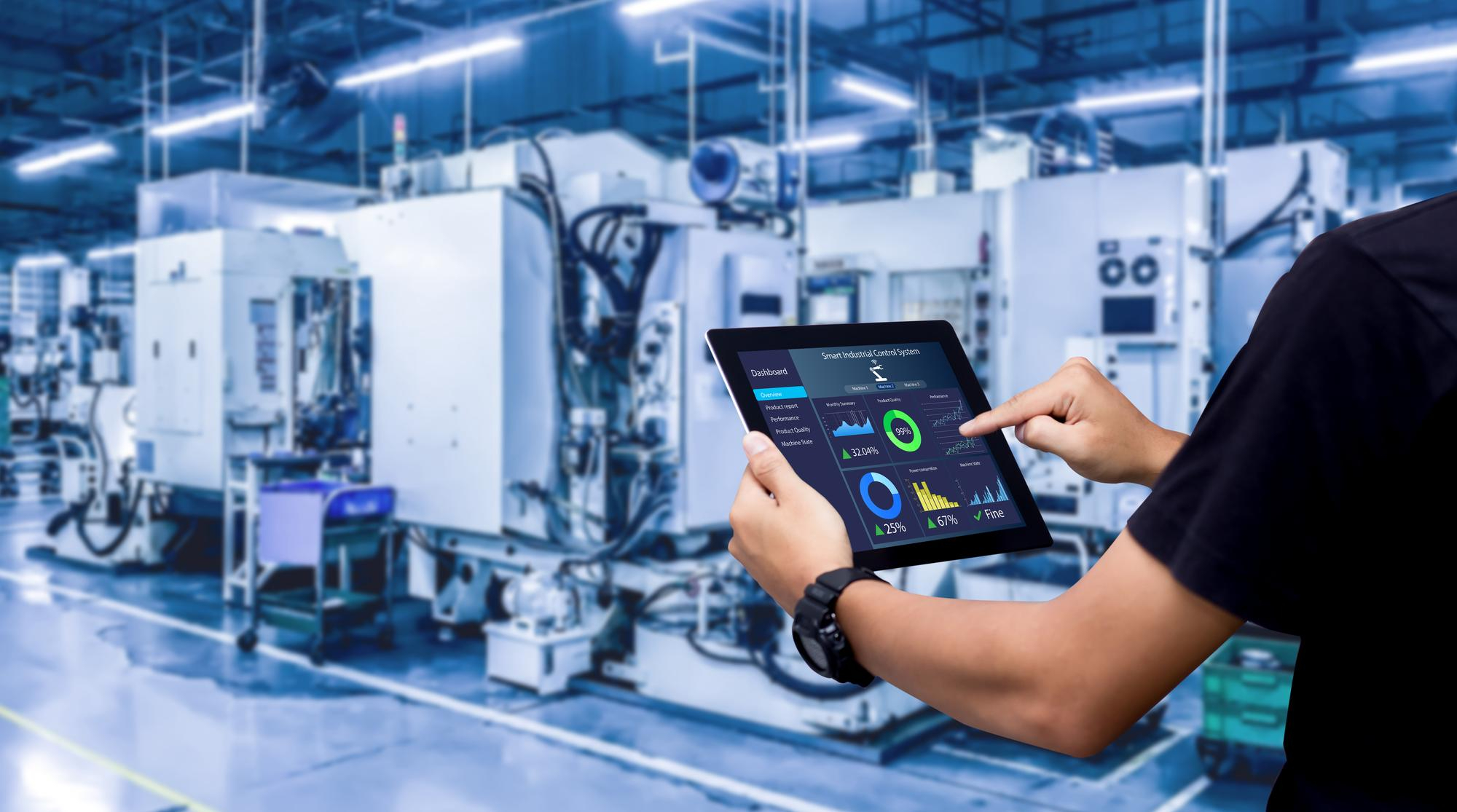 smart-industry-control-concepthands-holding-tablet-blurred-automation-machine-as-background